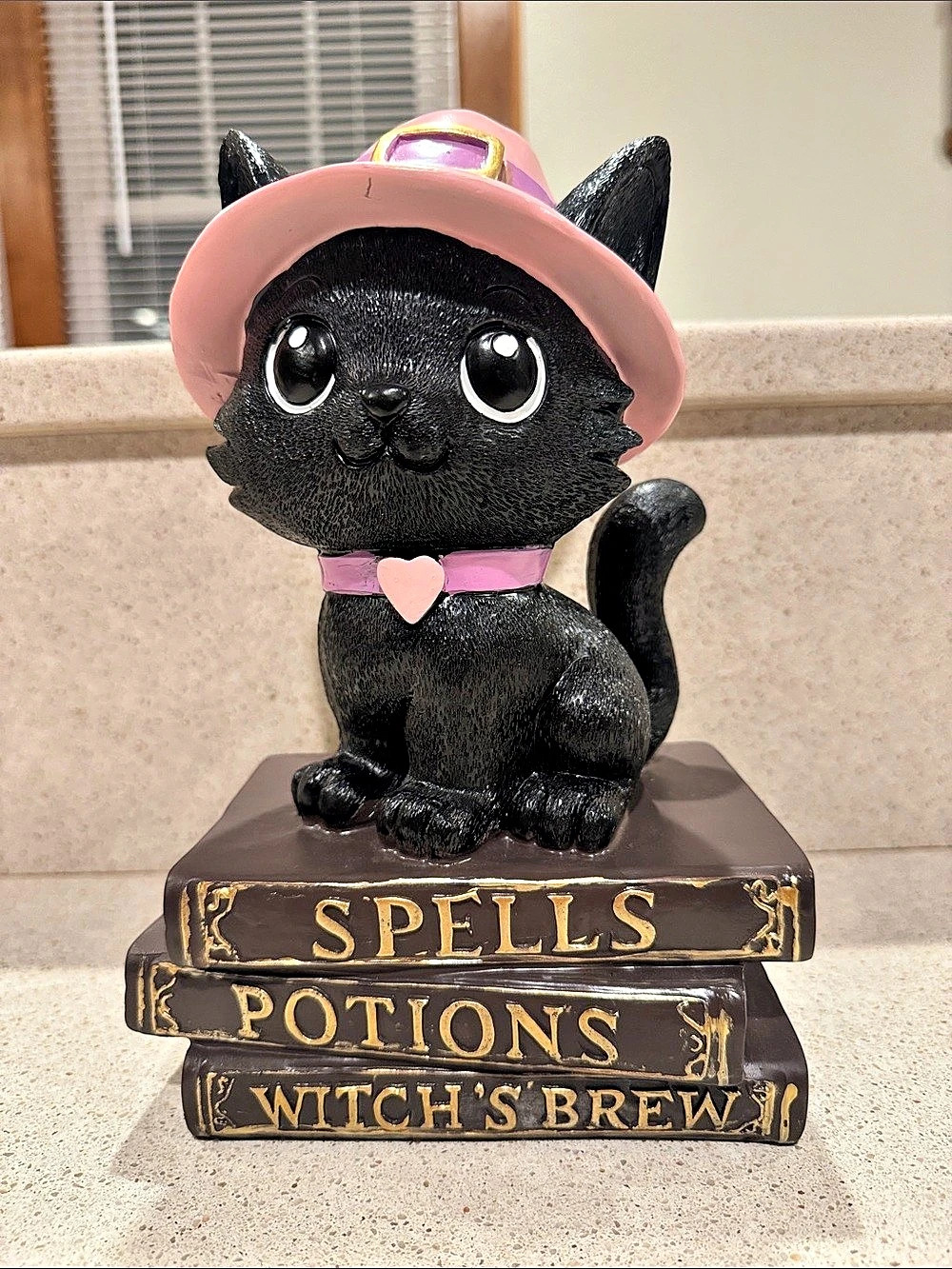 Halloween Black Cat Witch Figurine Decor atop Spell and Potions Book